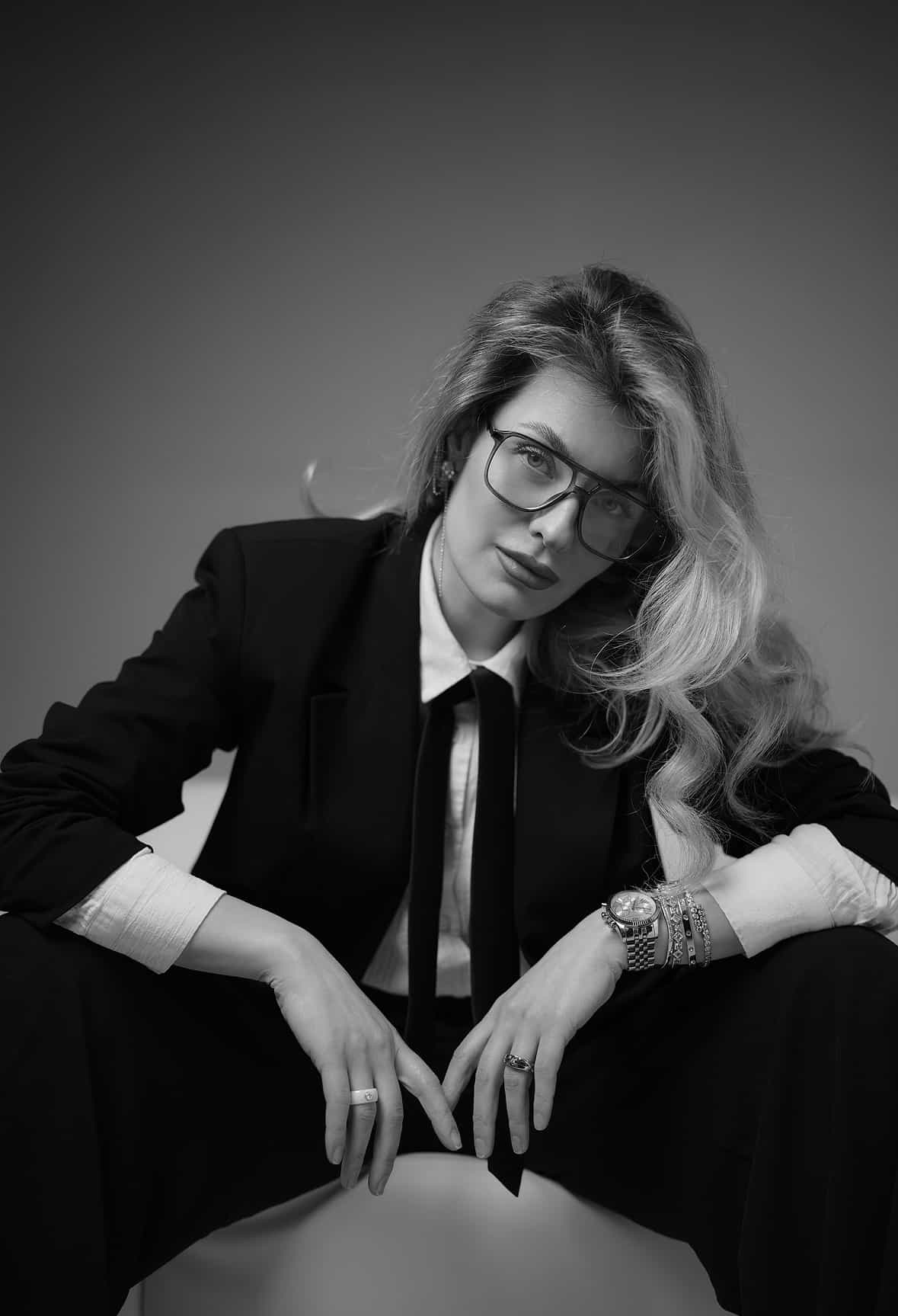 Studio portrait of a woman wearing a black suit