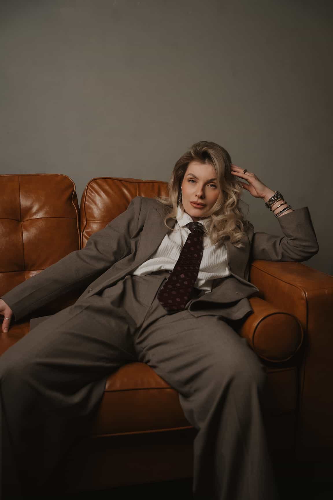 Editorial portrait of a woman in a gray suit